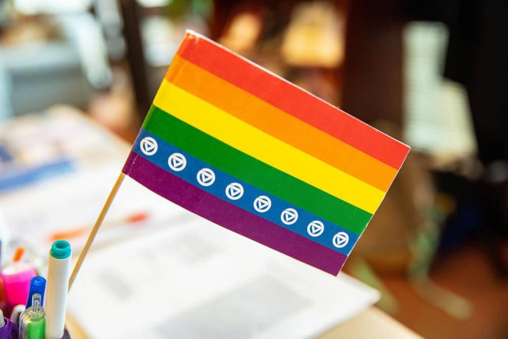 Pride flag with GVSU symbol on the blue stripe